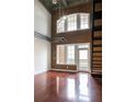 Loft-style living room with brick accent wall, soaring ceilings, and hardwood floors at 264 19Th Nw St # 2308, Atlanta, GA 30363