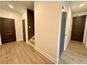 Bright hallway with hardwood floors, neutral walls, and access to multiple rooms in the home at 556 Sawnee Village Blvd # D76, Cumming, GA 30040
