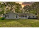 Charming single-story home with light-blue siding, a white front porch, and a well-maintained front yard at 806 Jefferson Sw Ct, Conyers, GA 30094
