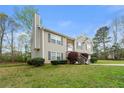A two-story home features stone accents, complemented by a well-manicured lawn at 313 Daniel Mill Xing, Villa Rica, GA 30180