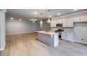 Modern kitchen with stainless appliances, center island and open concept living space at 3904 Shelleydale Dr, Powder Springs, GA 30127