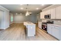 Modern kitchen with stainless appliances, and open-concept living space at 3904 Shelleydale Dr, Powder Springs, GA 30127