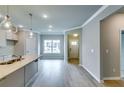 Bright, open-concept living space with light gray walls, crown molding and hardwood floors at 3904 Shelleydale Dr, Powder Springs, GA 30127