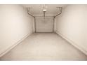 Clean, empty garage with white walls and a concrete floor, ready for parking and storage at 530 Sawnee Village Blvd # D63, Cumming, GA 30040