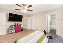 Spacious bedroom featuring a ceiling fan, carpet flooring, and an ensuite bathroom at 647 Sunshine Nw Trce, Acworth, GA 30102