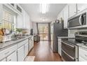 Modern kitchen with stainless steel appliances, granite countertops, and a view to the outdoor deck at 647 Sunshine Nw Trce, Acworth, GA 30102