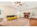Inviting living room with a cozy fireplace, plush carpet, and ample natural light at 647 Sunshine Nw Trce, Acworth, GA 30102