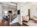 A modern living room featuring hardwood floors, a staircase, and elegant furniture at 1515 Walker Ave, Atlanta, GA 30337