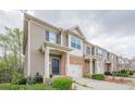 Street view of townhomes with brick accents, attached garages, and manicured front yards at 2705 Maple Park Pl # 29, Cumming, GA 30041