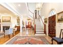 Grand foyer showcases a soaring staircase, gleaming marble floors, and exquisite detailing at 3022 Loridan Se Way, Atlanta, GA 30339