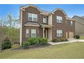 Attractive two-story brick home with a covered entrance and a neatly landscaped front yard at 3725 Rifflewood Way, Douglasville, GA 30135
