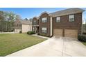 Charming two-story brick home featuring a spacious driveway and well-maintained landscaping at 3725 Rifflewood Way, Douglasville, GA 30135