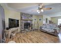 Bright living room featuring a stone fireplace and wood-look laminate floors at 38 E Boxwood Se Dr, Cartersville, GA 30121
