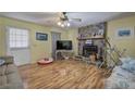 Cozy living room with stone fireplace, wood-look laminate floors, and natural light at 38 E Boxwood Se Dr, Cartersville, GA 30121