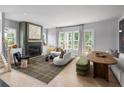 Cozy living room with a fireplace, neutral decor, and lots of natural light at 1456 Wicker Wood Se Pl # 15, Smyrna, GA 30080