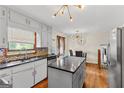 Bright kitchen featuring granite countertops, mosaic backsplash, and a stylish pendant light at 5429 Golfcrest Cir, Stone Mountain, GA 30088