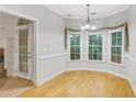 Bright dining area with hardwood floors and natural light from large windows at 3570 Bulloch Lake Rd, Loganville, GA 30052