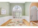 Elegant dining room with hardwood floors, chandelier, and large window at 3570 Bulloch Lake Rd, Loganville, GA 30052