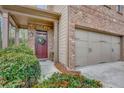 Close up of home exterior with a two-car garage and inviting brick porch at 4974 Whiteoak Walk Se # 21, Smyrna, GA 30080