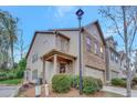 Inviting two-story home with a brick facade, covered porch, and manicured landscaping at 4974 Whiteoak Walk Se # 21, Smyrna, GA 30080