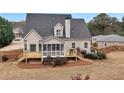 Back exterior featuring a new deck with stairs to the ground and a screened in porch at 52 Weatherstone Way, Dallas, GA 30157