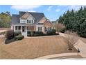 Charming two-story home featuring stone accents, a welcoming porch, and beautifully landscaped front yard at 52 Weatherstone Way, Dallas, GA 30157