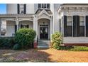 Charming front entrance with brick steps and lush landscaping leading to a classic double-door entryway at 285 Kennesaw Nw Ave, Marietta, GA 30060
