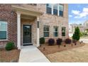 Charming brick home entrance with manicured landscaping and a welcoming walkway at 3420 Reagan Way, Lawrenceville, GA 30044