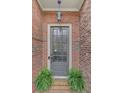A welcoming brick entryway featuring a stylish front door with glass panels and decorative ferns at 4428 Wilkerson Manor Se Dr # 6, Smyrna, GA 30080