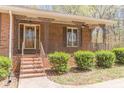 Inviting front porch with decorative metal railings, a ceiling fan, and well-manicured bushes at 452 Hightower Ridge Rd, Covington, GA 30014