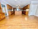 Open concept kitchen featuring wood cabinets, hardwood floors, and modern appliances at 512 Clearwater Dr, Mcdonough, GA 30252