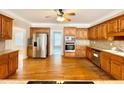 Spacious kitchen with wood cabinets, stainless steel appliances, and hardwood floors at 512 Clearwater Dr, Mcdonough, GA 30252