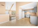 Open kitchen layout with tile floors and stainless steel appliances. Lots of natural light at 6422 Phillips Ct, Lithonia, GA 30058