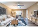 Inviting living room featuring neutral walls, a ceiling fan, stylish decor and LVP flooring at 6851 Roswell Rd # A-12, Atlanta, GA 30328