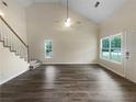 Bright living room featuring vaulted ceiling, ample natural light, and hard surface flooring at 7747 Rountree Xing, Riverdale, GA 30274