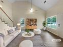 Bright living room featuring vaulted ceiling, ample natural light, and modern decor for a welcoming space at 7747 Rountree Xing, Riverdale, GA 30274