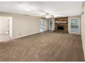 Spacious living room featuring a brick fireplace and large windows at 2610 Betty Jean Dr, Jonesboro, GA 30236