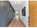 Elegant hallway with hardwood floors, modern light fixture, and decorative wall paneling at 1598 Athens Ave, Atlanta, GA 30310