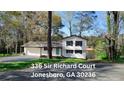 Charming exterior of this two-story home in Jonesboro, GA, with manicured lawn at 336 Sir Richard Ct, Jonesboro, GA 30236