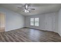 Bright living room with hardwood floors and a modern ceiling fan at 643 Tumlin Lake Rd, Temple, GA 30179