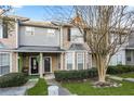 Inviting townhouse with landscaped front yard, covered entrance, and a combination of brick and vinyl facade at 109 Odyssey, Conyers, GA 30012