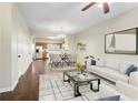 A view of the open-plan living room and dining area featuring stylish decor and hardwood floors at 109 Odyssey, Conyers, GA 30012