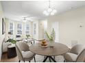 Inviting living room filled with light boasting a ceiling fan, multiple windows and hardwood floors at 109 Odyssey, Conyers, GA 30012
