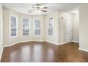 Bright living room featuring hardwood floors, large windows, and a ceiling fan for comfortable living at 109 Odyssey, Conyers, GA 30012