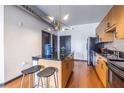 Bright kitchen includes an island with stools, stainless appliances, and wood cabinetry at 5300 Peachtree Rd # 3206, Atlanta, GA 30341