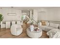 Open-concept living space with dining area, modern furnishings, and hardwood floors, perfect for entertaining at 1337 Grey Fox Ne Ct, Atlanta, GA 30306