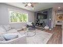 Cozy living room featuring a large window, modern decor, and wood-look flooring at 418 Robinson Rd, Peachtree City, GA 30269