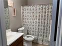 Cozy bathroom with a patterned shower curtain and neutral wall color at 6490 Emerald Pointe Circle, Atlanta, GA 30349