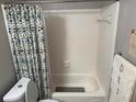 Functional bathroom featuring a shower-tub combo, neutral tiling, and coordinating accessories at 6490 Emerald Pointe Circle, Atlanta, GA 30349