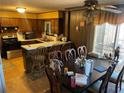 Cozy kitchen with breakfast bar and dining table with wood cabinets at 6675 Hidden Brook Trl, Atlanta, GA 30349